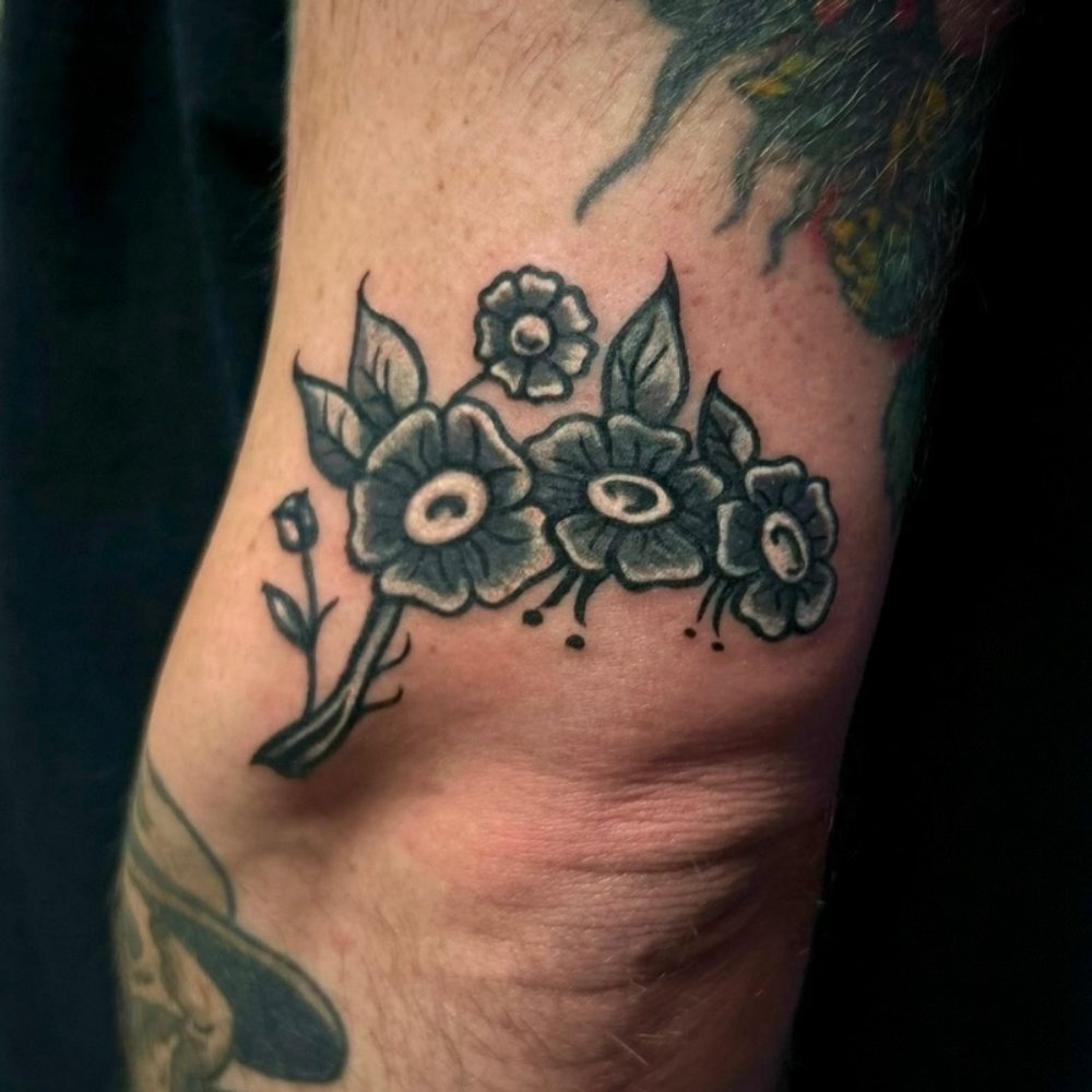 Black-and-grey traditional flowers tattoo