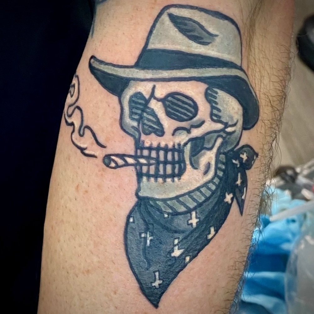 Traditional skull with fedora and bandana tattoo