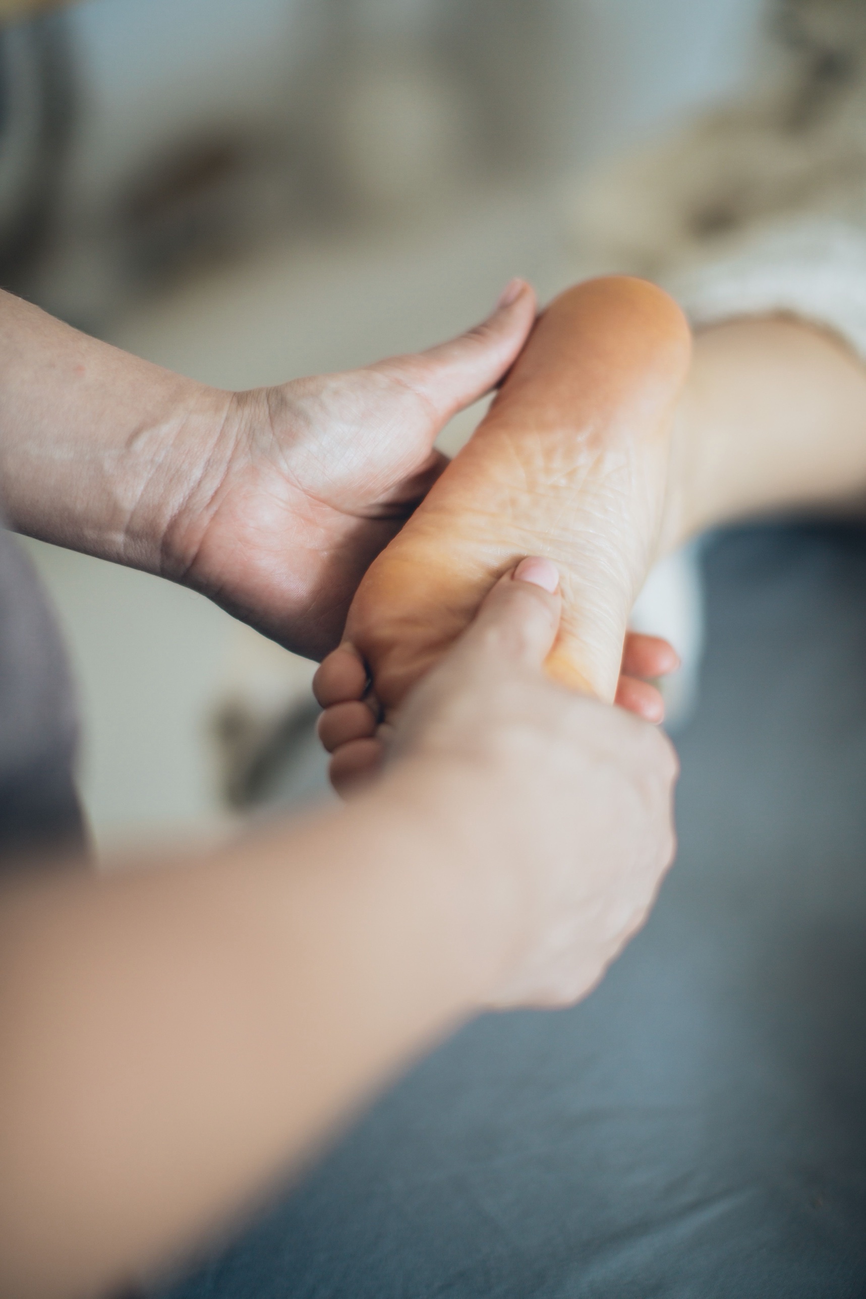 Hands cradling a foot during a foot detox treatment