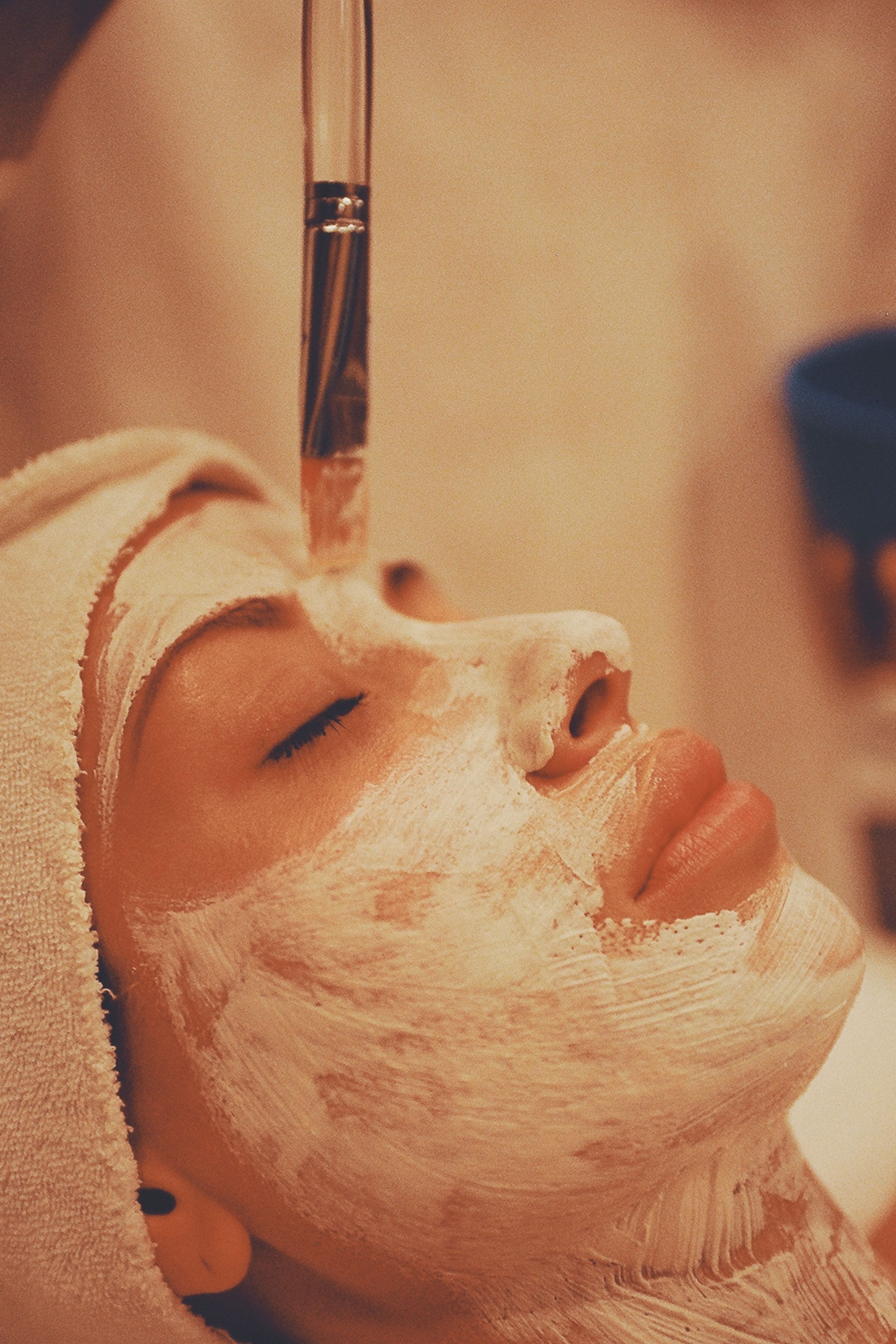 Close-up of a hydrating mask applied to a woman's face during a facial treatment